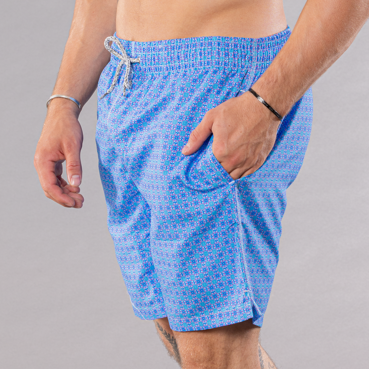 Men&#39;s blue/coral swim trunks with ethnic tile pattern