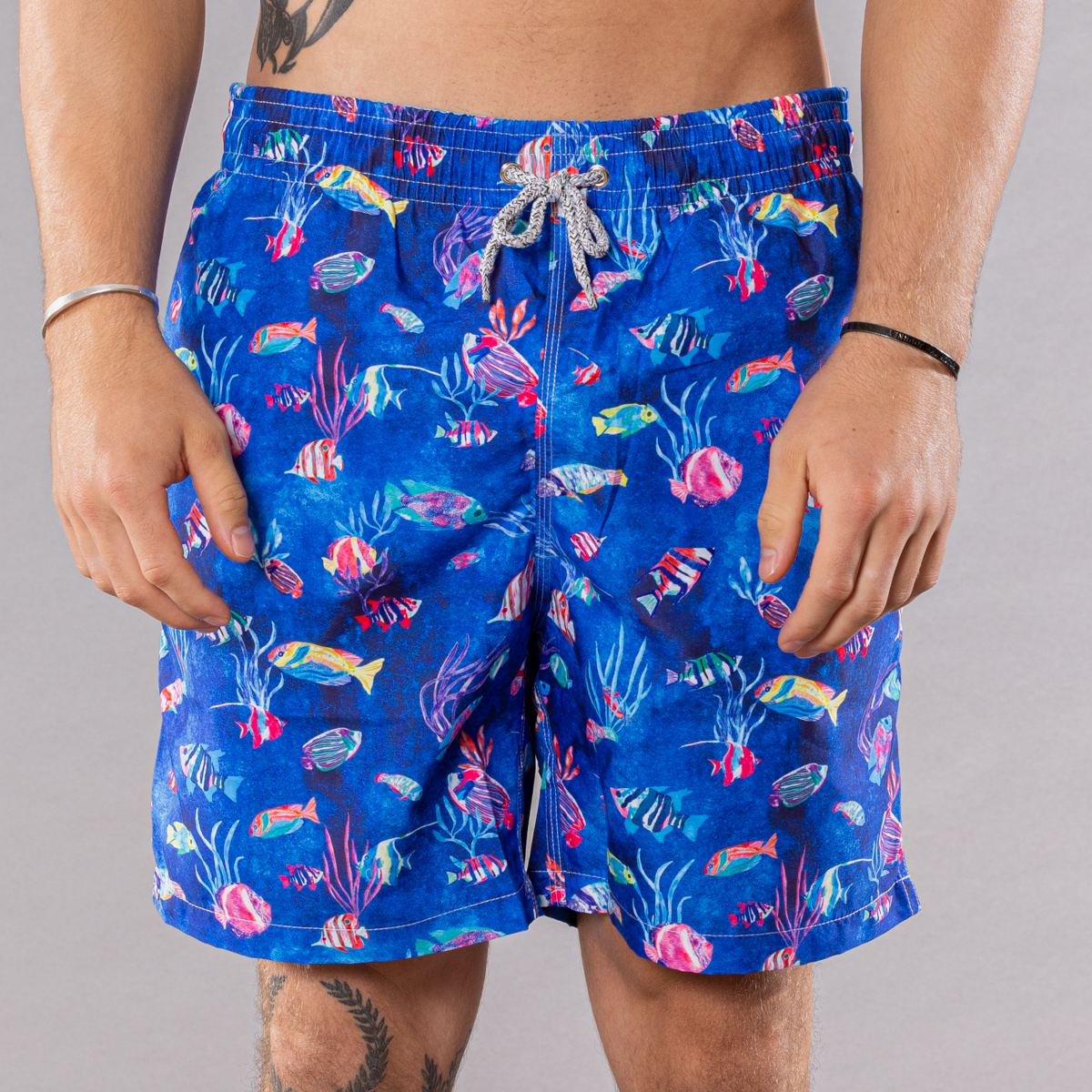 Men&#39;s blue swim trunks with cyclist liner, tropical reef pattern, front view
