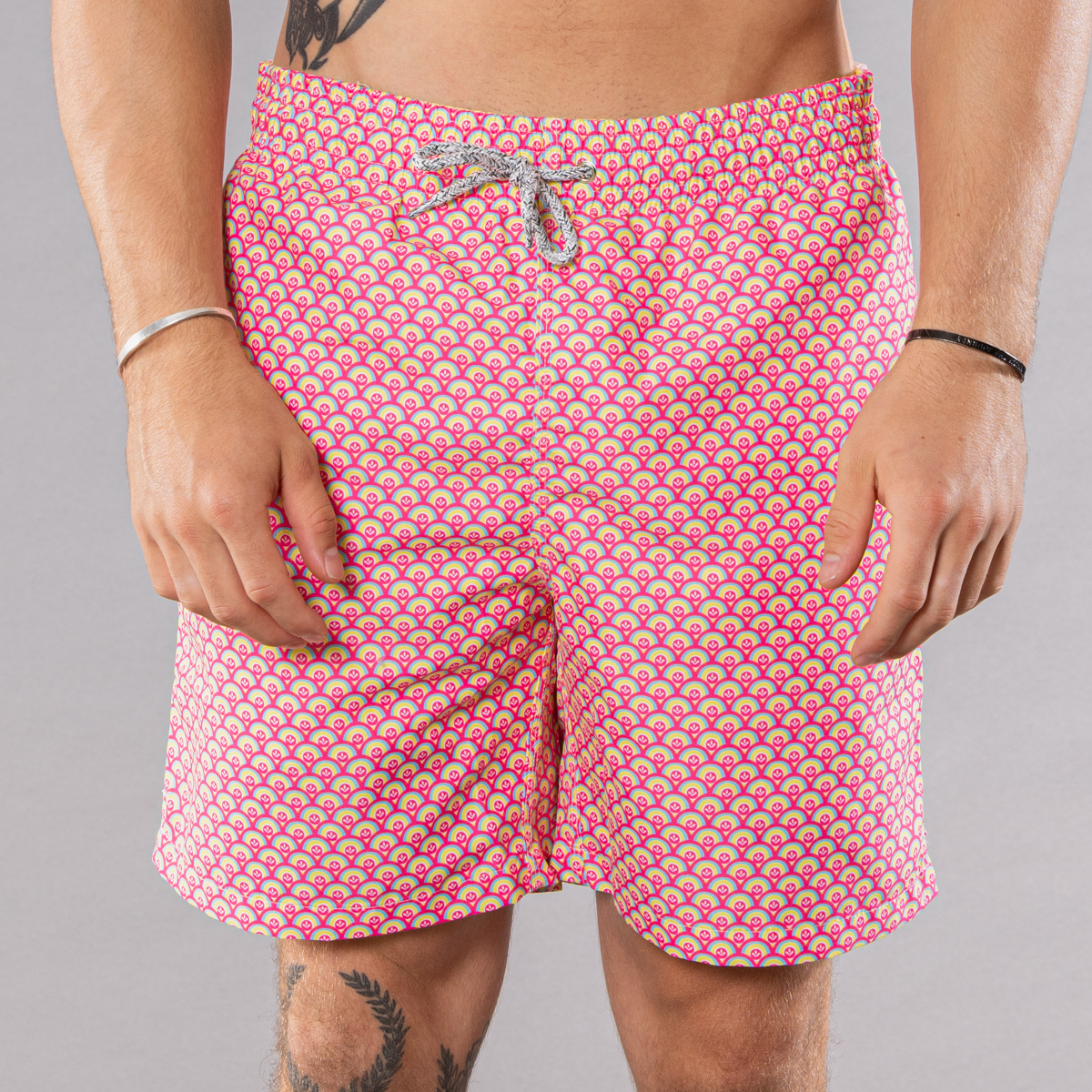 Men&#39;s coral/yellow swim trunks with cyclist liner, half moons pattern, front view