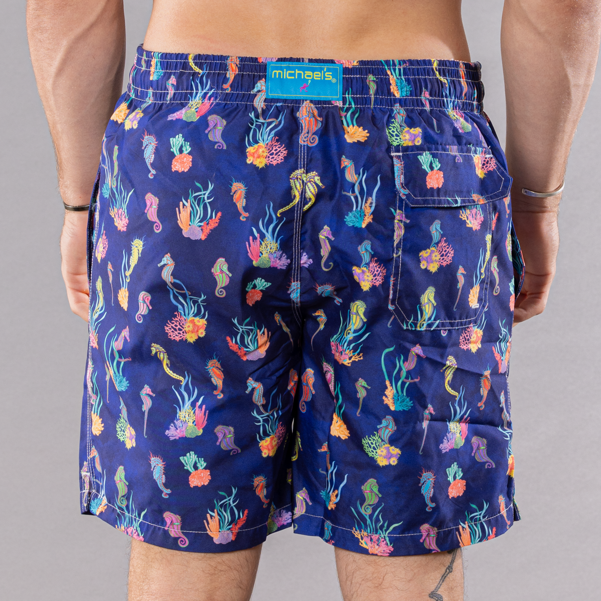 Men&#39;s navy swim trunks with seahorses &amp; coral pattern, back view