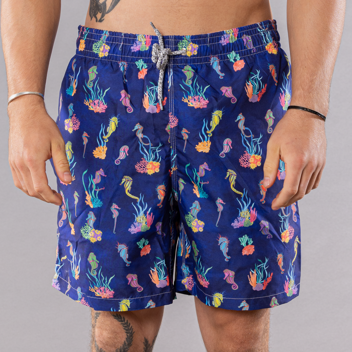 Men&#39;s navy swim trunks with seahorses &amp; coral pattern, front view