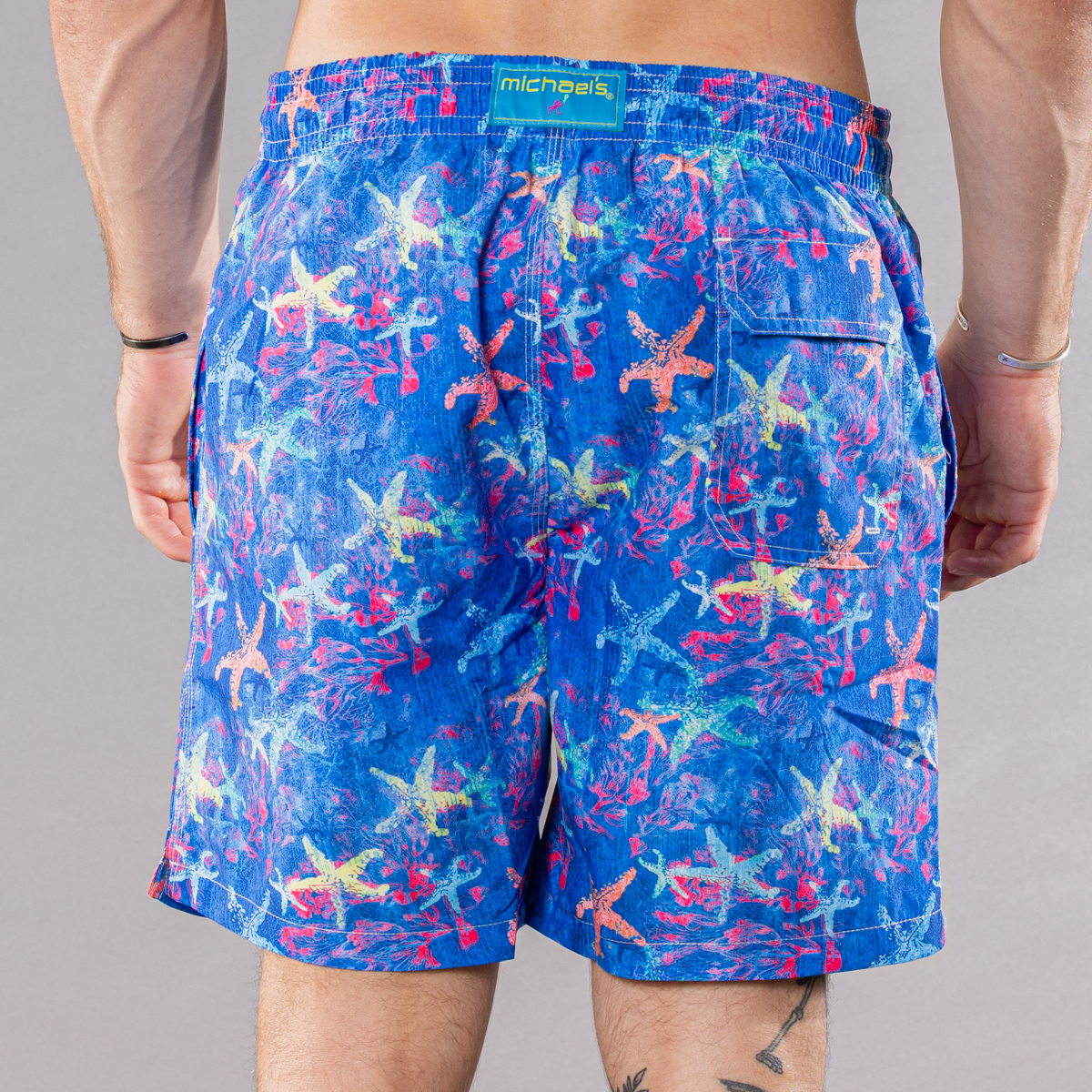 Men&#39;s navy swim trunks with starfish pattern, back view