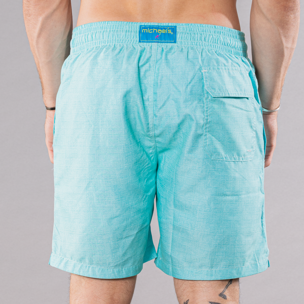 Men&#39;s solid aqua swim trunks with cyclist liner, back view