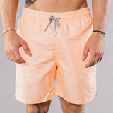 Men's solid print swim trunks in orange, front view
