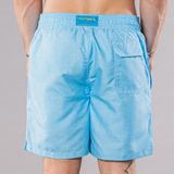 Men's solid print swim trunks in turquoise, back view
