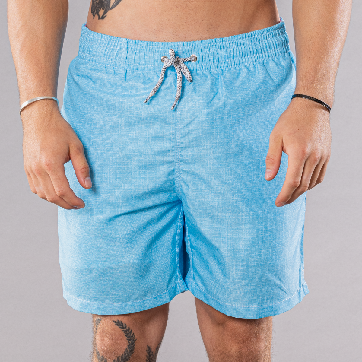 Men&#39;s solid print swim trunks in turquoise, front view