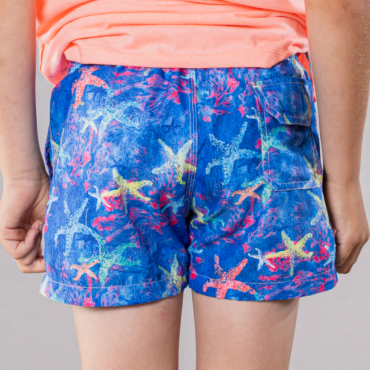 Navy swim trunks with starfish pattern for boys, back view